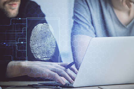 Fingerprint hologram with businessman working on computer on background. Security concept. Double...