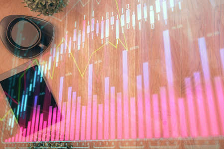 Multi exposure of financial chart hologram over desktop with phone. Top view. Mobile trade platform...