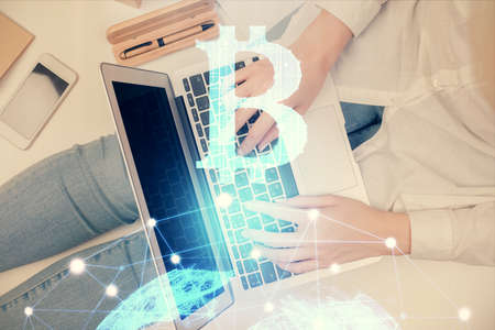 Double exposure of woman hands working on computer and blockchain theme hologram drawing. Top View....