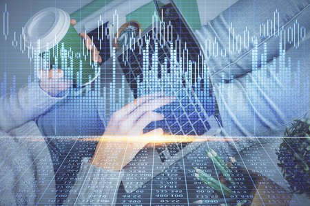 Double exposure of woman hands typing on computer and forex chart hologram drawing. Stock market...