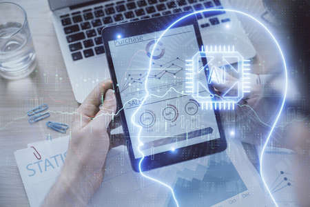 Double exposure of mans hand holding and using a digital device and brain hologram drawing. Data...