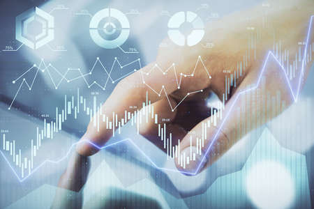Multi exposure of mans hands holding and using a phone and financial chart drawing. Market analysis...
