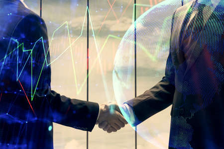 Double exposure of forex graph hologram and handshake of two men. Stock market concept.の写真素材