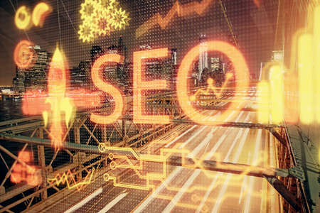 SEO hologram on city view with skyscrapers background double exposure. Search optimization concept.