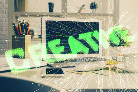 Desktop computer background in office and start up theme hologram drawing. Double exposure. Startup concept.の写真素材