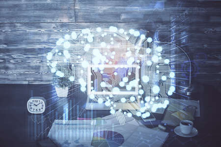 Multi exposure of work space with computer and human brain hologram. Brainstorm concept.