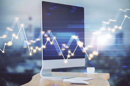 Forex market chart hologram and personal computer background. Double exposure. Concept of...
