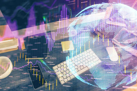 Double exposure of forex graph and work space with computer. Concept of international online...