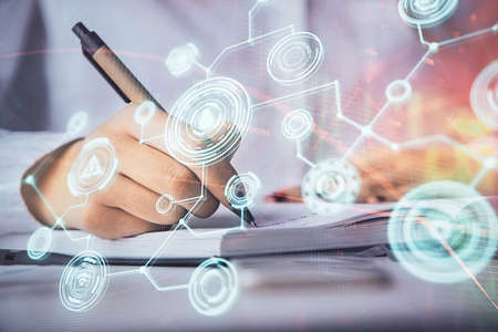 Social network theme hologram over hands taking notes background. Concept of global international people connect. Double exposureの写真素材