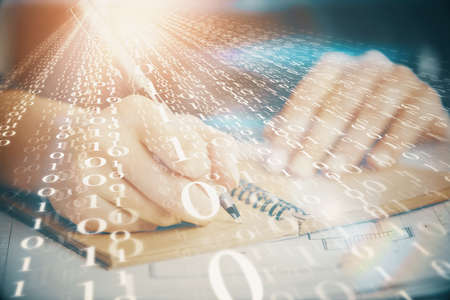 Double exposure of writing hands on background with data solution hologram on front. Technology...