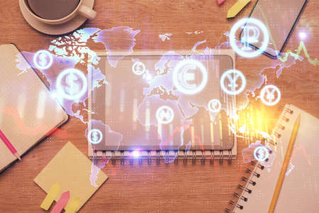 Double exposure of forex chart hologram over desktop with phone. Top view. Mobile trade platform...
