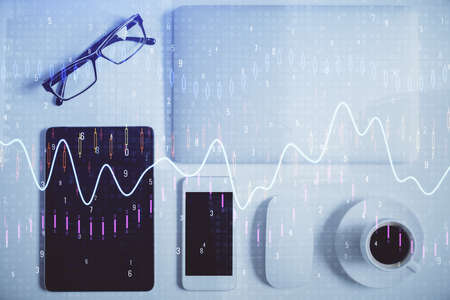 Double exposure of forex chart hologram over desktop with phone. Top view. Mobile trade platform concept.の写真素材