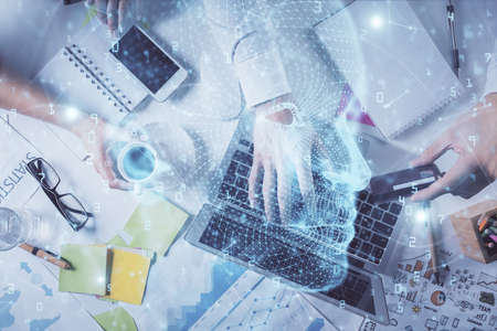 Double exposure of mans hands typing over computer keyboard and brain hologram drawing. Top view. Ai and data technology concept.の写真素材