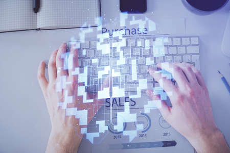 Multi exposure of mans hands typing over computer keyboard and data theme hologram drawing. Top...