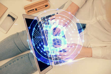 Double exposure of woman hands working on computer and blockchain theme hologram drawing. Top View....