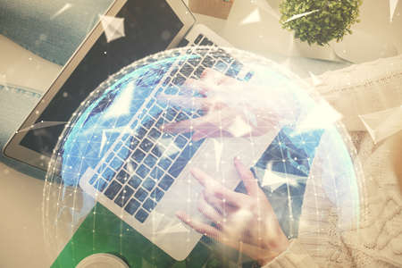 Double exposure of woman hands working on computer and financial theme hologram drawing. Top View. Business concept.の写真素材