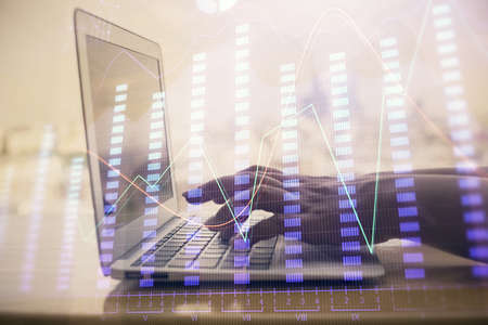Double exposure of woman hands typing on computer and forex chart hologram drawing. Stock market...