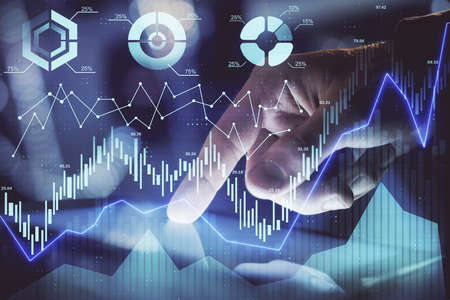 Multi exposure of mans hands holding and using a phone and financial chart drawing. Market analysis...
