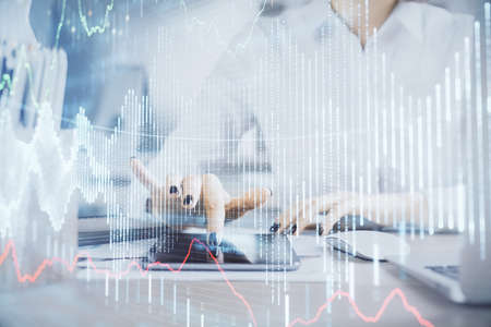 Double exposure of forex chart sketch hologram and woman holding and using a mobile device. Financial market concept.の写真素材