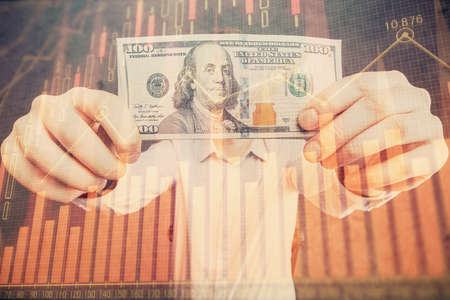 Multi exposure of forex graph drawing hologram and USA dollars bills and man hands. Technical Analysis concept.の写真素材