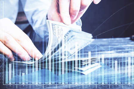 Multi exposure of forex graph drawing hologram and USA dollars bills and man hands. Technical...