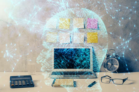 Double exposure of desktop with computer and brain drawing hologram. Artificial intelligence...