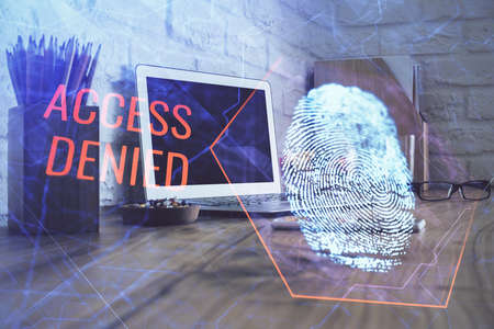 Computer on desktop in office with finger print drawing. Double exposure. Concept of business data...