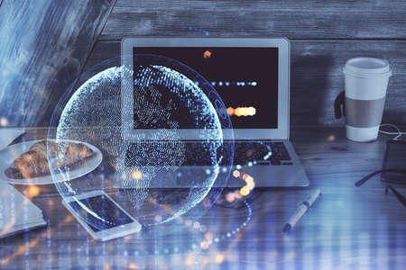 Multi exposure of table with computer and world map hologram. International data network concept.