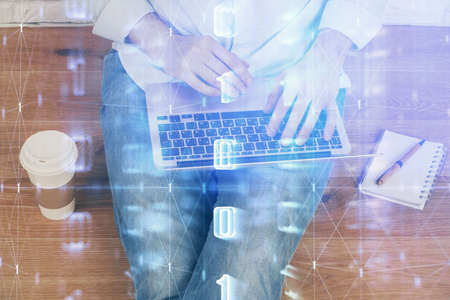 Multi exposure of data internet theme hologram with man working on computer on background. Concept...
