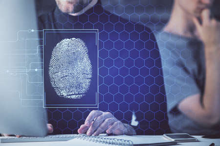Fingerprint hologram with businessman working on computer on background. Security concept. Double...