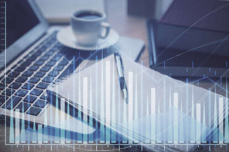 Double exposure of forex chart drawing and desktop with coffee and items on table background....