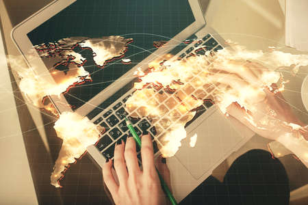 Double exposure of woman hands working on computer and financial theme hologram drawing. Top View....