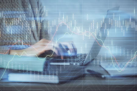 Double exposure of woman hands typing on computer and forex chart hologram drawing. Stock market...