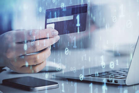 Double exposure of woman on-line shopping holding a credit card and data theme hologram drawing....