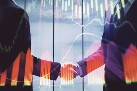Double exposure of forex graph hologram and handshake of two men. Stock market concept.
