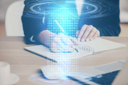 Double exposure of writing hands on background with data solution hologram on front. Technology...