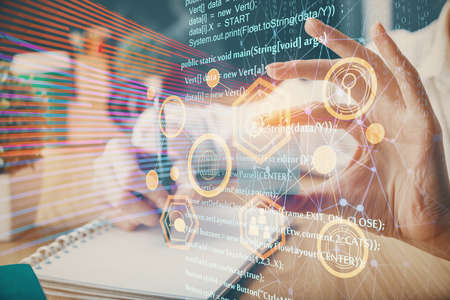Multi exposure of writing hands on background with data solution hologram. Technology concept.の写真素材