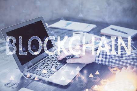 Blockchain theme hologram with man working on computer on background. Concept of crypto chain. Double exposure.の写真素材