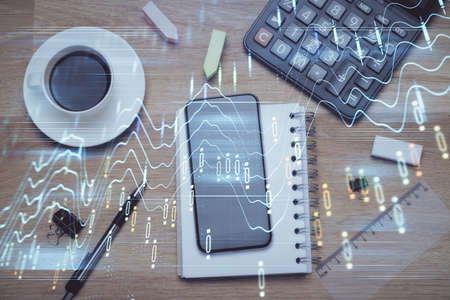 Multi exposure of forex graph hologram over desktop with phone. Top view. Mobile trade platform...