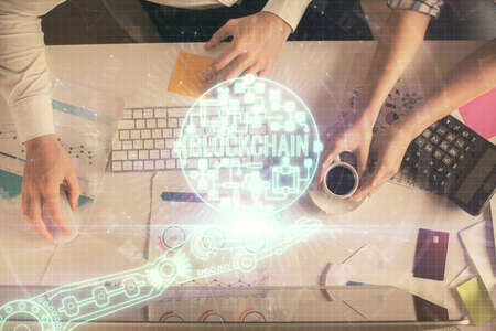 Double exposure of man and woman working together and crypto theme hologram drawing. Computer background. Blockchain concept. Top View.の写真素材