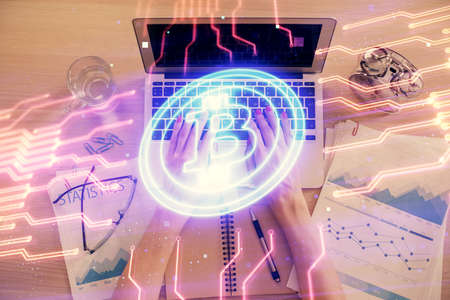 Double exposure of woman hands working on computer and blockchain theme hologram drawing. Top View. bitcoin cryptocurrency concept.の写真素材