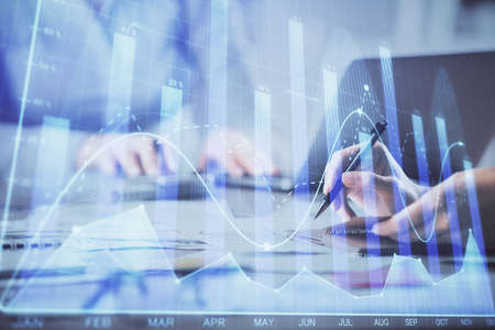 Multi exposure of woman hands typing on computer and financial chart hologram drawing. Stock market...