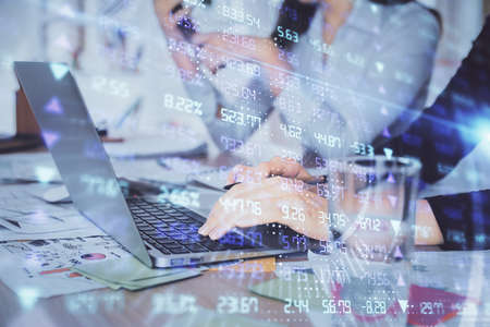 Multi exposure of woman hands typing on computer and forex chart hologram drawing. Stock market...