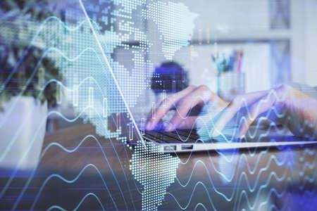 Double exposure of woman hands typing on computer and forex chart hologram drawing. Stock market...