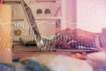 Double exposure of woman hands typing on computer and forex chart hologram drawing. Stock market...