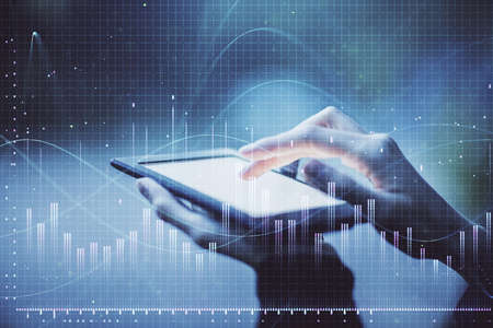 Double exposure of forex chart sketch hologram and woman holding and using a mobile device....