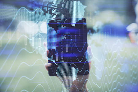 Double exposure of forex chart sketch hologram and woman holding and using a mobile device. Financial market concept.の写真素材