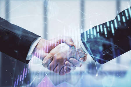 Double exposure of forex graph hologram and handshake of two men. Stock market concept.