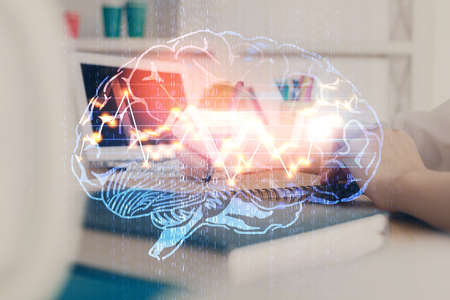 Multi exposure of writing hand on background with brain hologram. Concept of learning.の写真素材