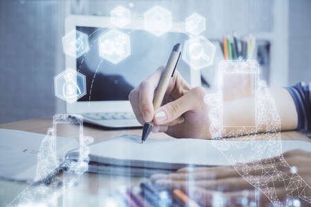 Tech theme hologram over womans hands taking notes background. Concept of hightech. Double exposure